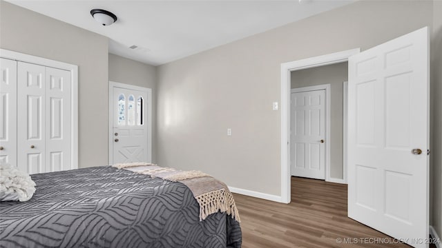 bedroom with hardwood / wood-style flooring and a closet