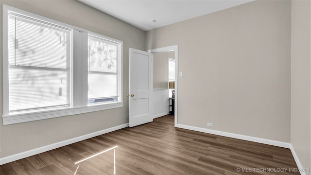 empty room with wood-type flooring