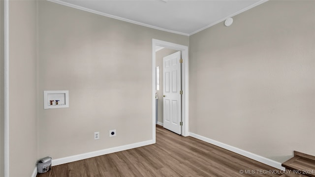 washroom featuring hookup for a washing machine, crown molding, electric dryer hookup, and wood-type flooring