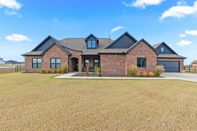 craftsman-style house featuring a garage and a front lawn