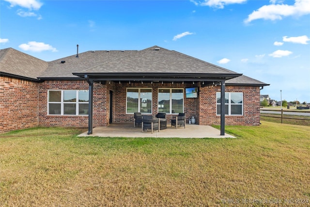 back of property with a yard and a patio