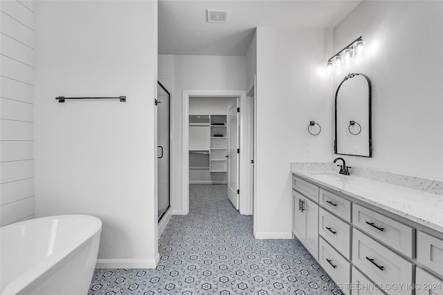 bathroom featuring vanity and separate shower and tub