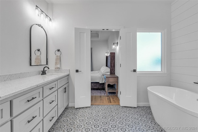 bathroom featuring tile patterned floors, a bathtub, and vanity