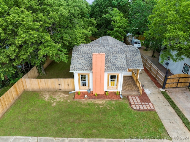 view of front of home with a shed and a front lawn