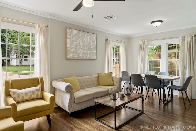 living room with crown molding, ceiling fan, a healthy amount of sunlight, and dark hardwood / wood-style flooring