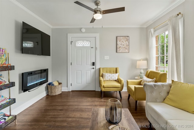 living room with dark wood-type flooring, crown molding, and ceiling fan