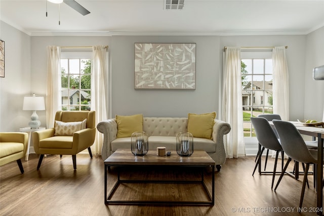 sitting room featuring crown molding, wood-type flooring, and plenty of natural light