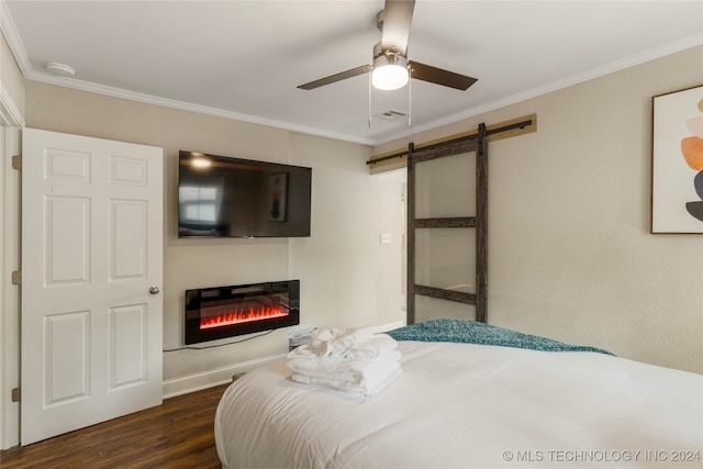 bedroom featuring dark hardwood / wood-style flooring, crown molding, a barn door, and ceiling fan