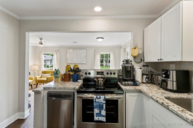 kitchen with a healthy amount of sunlight, stainless steel appliances, and white cabinets