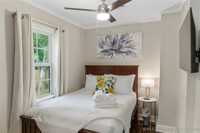 bedroom featuring crown molding, hardwood / wood-style flooring, and ceiling fan