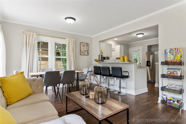 living room featuring dark wood-type flooring and ornamental molding