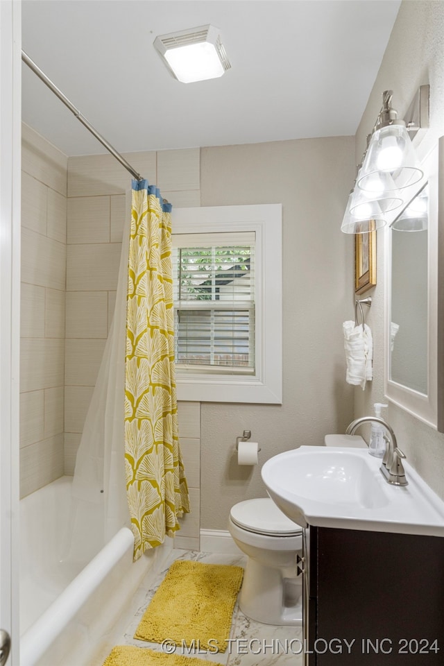 full bathroom featuring vanity, shower / bath combo with shower curtain, and toilet