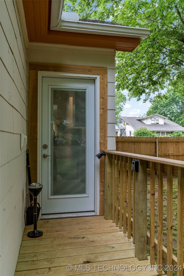 view of exterior entry with a deck