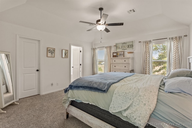 carpeted bedroom with ceiling fan and vaulted ceiling