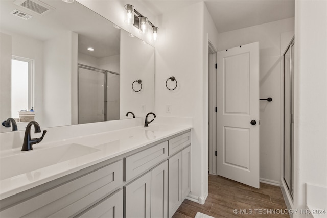 bathroom featuring vanity, hardwood / wood-style floors, and an enclosed shower