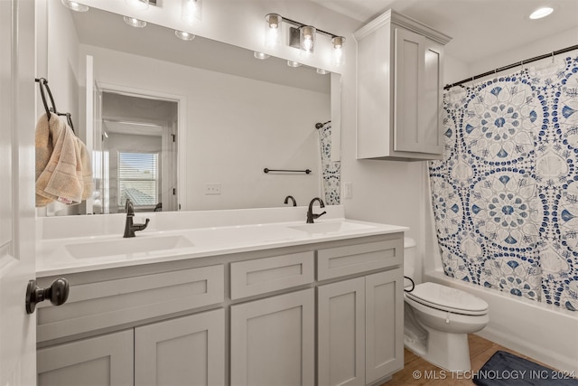 full bathroom featuring vanity, toilet, and shower / tub combo