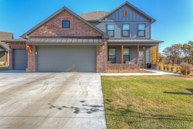 view of front facade featuring covered porch, a garage, and a front lawn