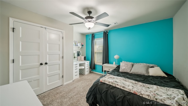 bedroom with light carpet, a closet, and ceiling fan