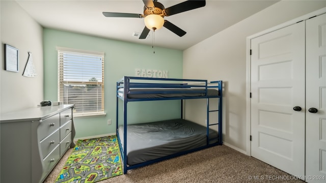 bedroom with a closet, ceiling fan, and carpet floors