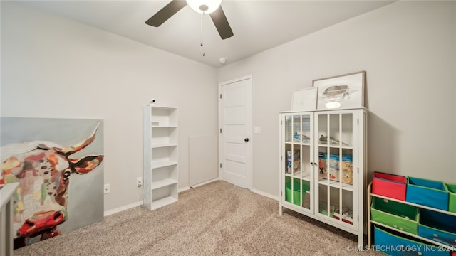 rec room featuring ceiling fan and carpet flooring