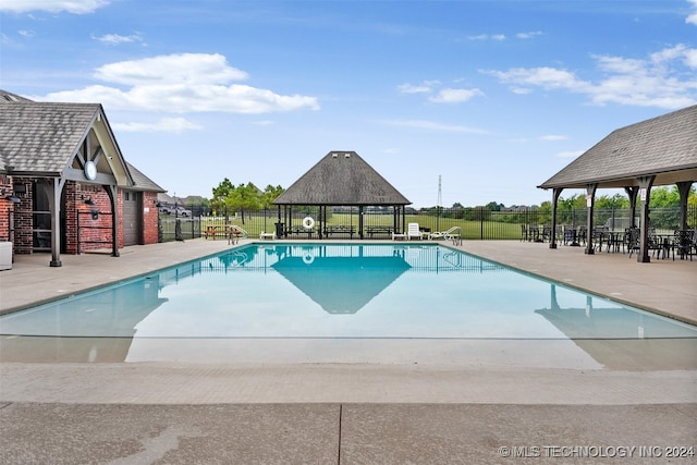 view of swimming pool with a gazebo and a patio area