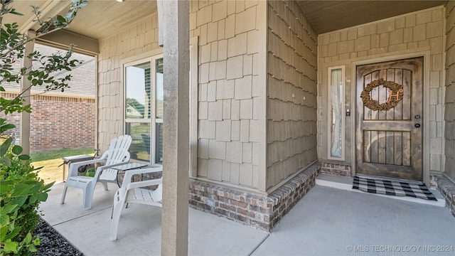 doorway to property featuring covered porch