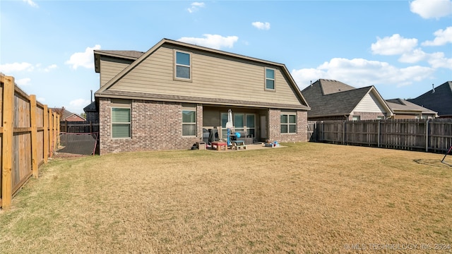 back of house featuring a yard and a patio area