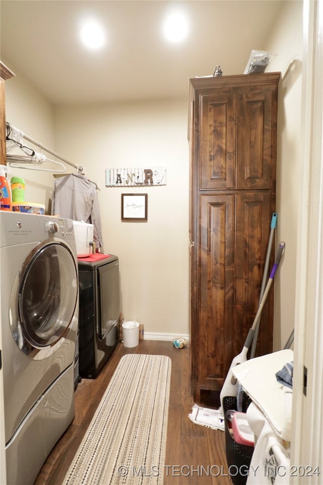 laundry area featuring dark wood-type flooring and washer and dryer