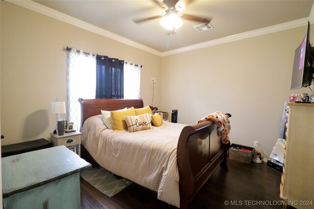 bedroom with ornamental molding, dark hardwood / wood-style floors, and ceiling fan