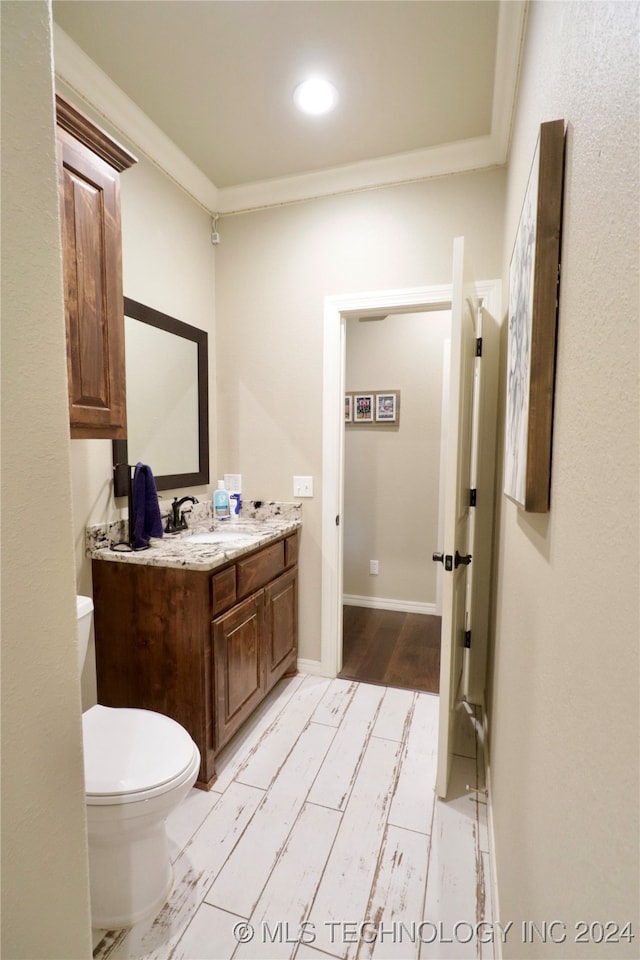 bathroom featuring hardwood / wood-style floors, vanity, and toilet