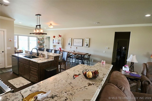 kitchen featuring a breakfast bar, stainless steel dishwasher, a kitchen island with sink, dark wood-type flooring, and pendant lighting