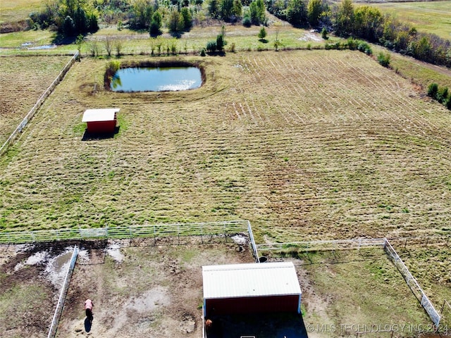 birds eye view of property with a rural view and a water view