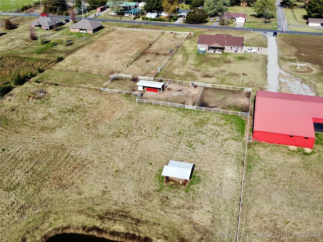 birds eye view of property with a rural view