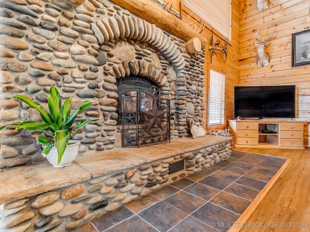 living room with wood walls, a high ceiling, and wood finished floors