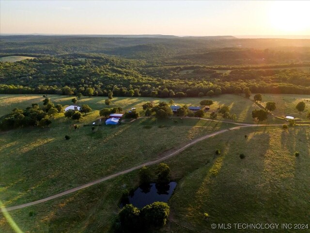 aerial view at dusk featuring a rural view