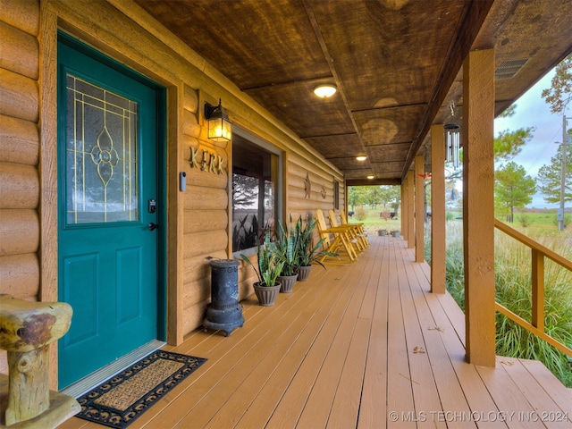 wooden terrace featuring covered porch