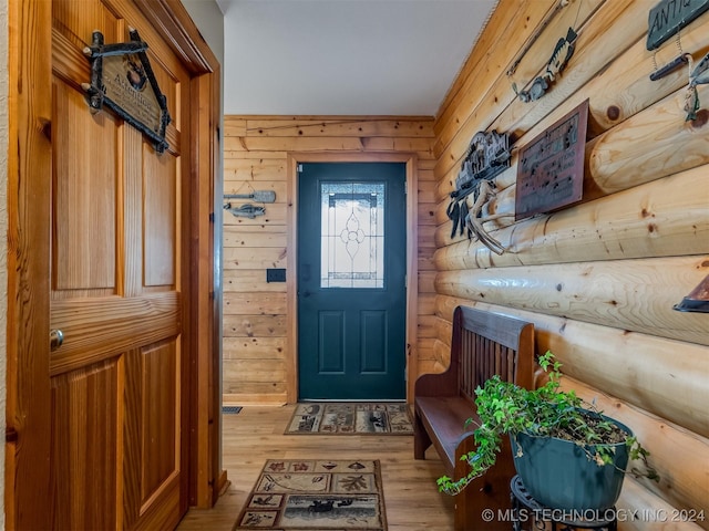 interior space featuring light wood finished floors and log walls