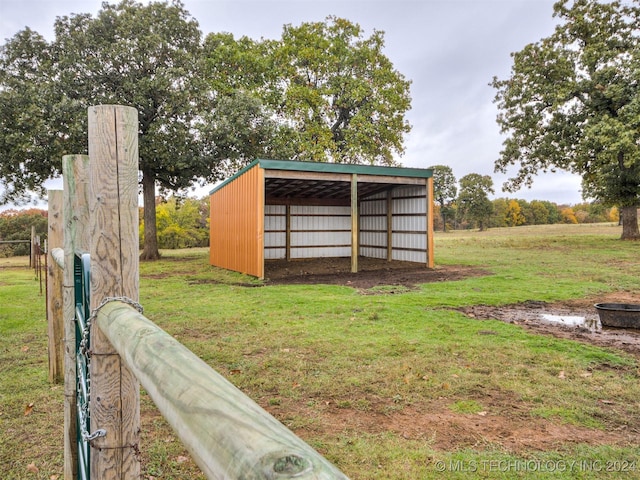 view of pole building with a lawn and a detached carport