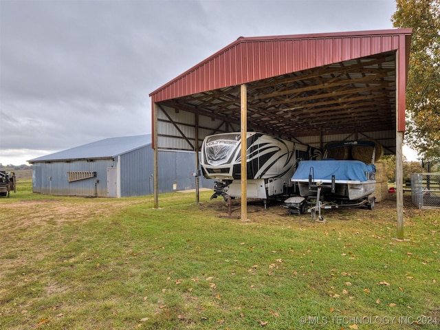 exterior space featuring a carport and an outbuilding