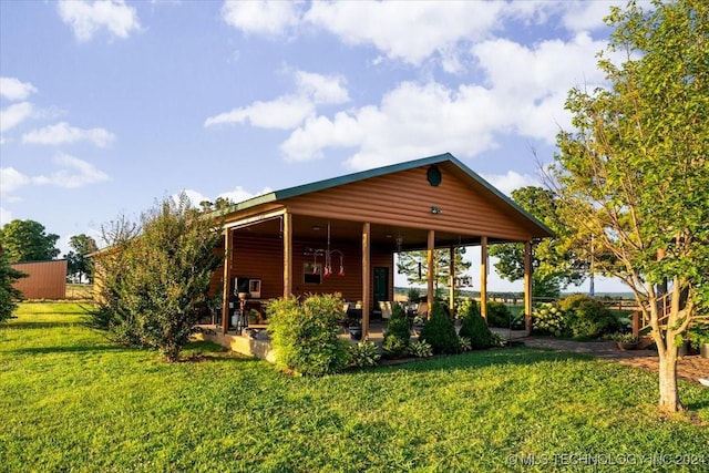 view of front of property with a front lawn and log veneer siding