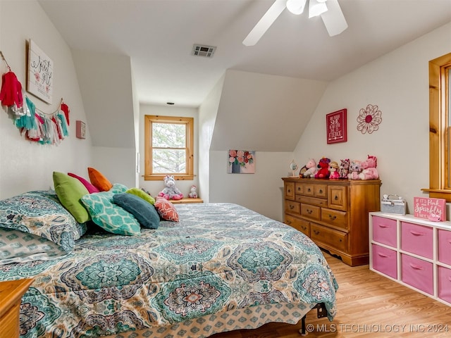 bedroom featuring vaulted ceiling, ceiling fan, light wood-type flooring, and visible vents