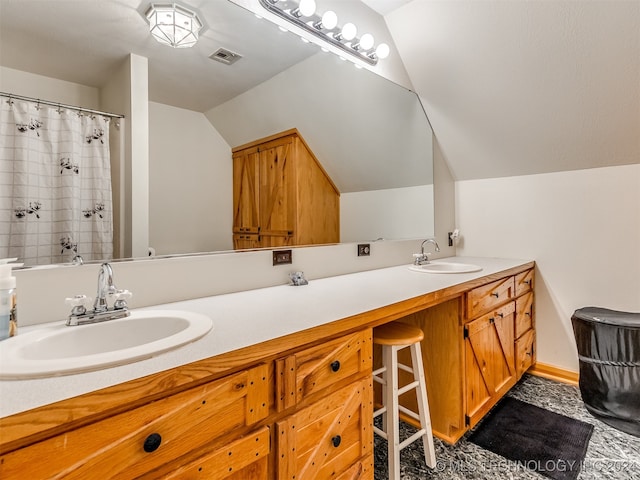 bathroom featuring vanity and vaulted ceiling