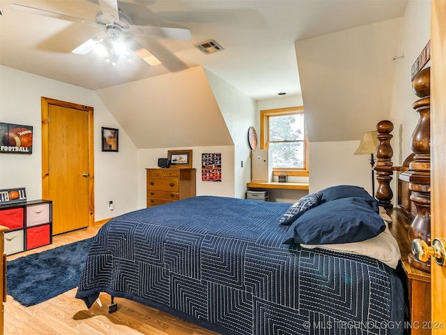 bedroom with lofted ceiling, wood-type flooring, and ceiling fan