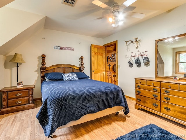 bedroom featuring baseboards, visible vents, ceiling fan, and light wood finished floors