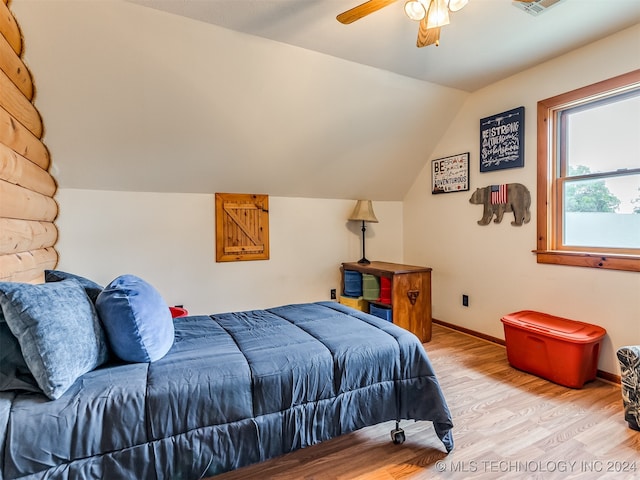 bedroom featuring light hardwood / wood-style floors, ceiling fan, and vaulted ceiling