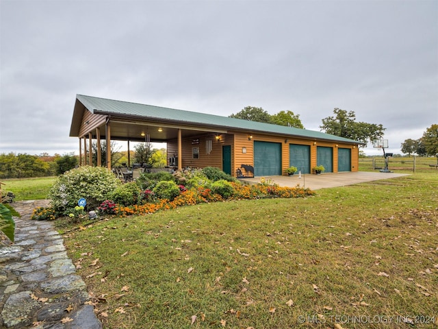 view of front of house featuring an attached garage, driveway, a front yard, and faux log siding