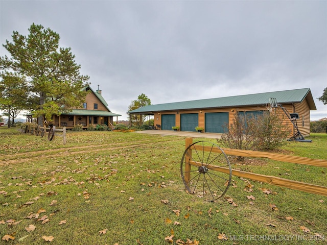 view of yard with a garage and driveway