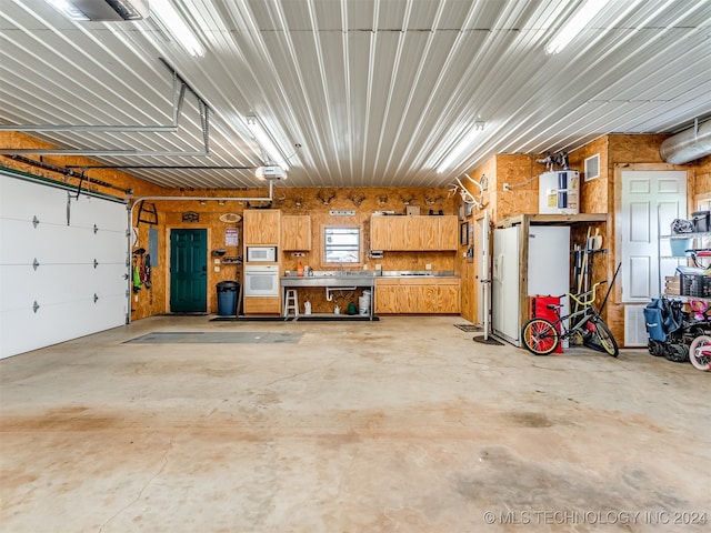 garage with a garage door opener and electric water heater