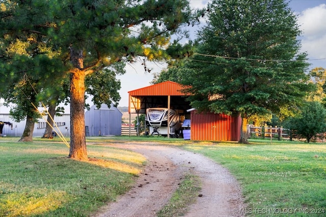 view of home's community featuring a lawn and an outbuilding