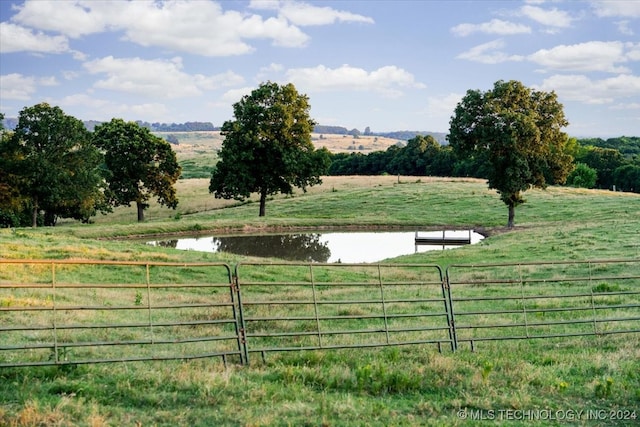 view of yard with a water view and a rural view